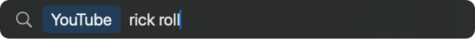 The launcher bar in argument mode: a YouTube pill, then the typed argument